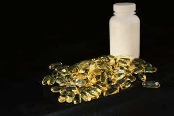 Omega3 gel capsules on black background. Soft Fish Oil Capsules. Floating fatty acids softgel...