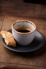 Cup of coffee on rustic wooden background. Soft focus. Copy space	