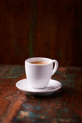 Cup of coffee on rustic wooden background. Soft focus. Copy space	