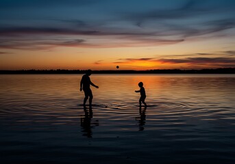 Fototapeta premium Family playing at sunset lake