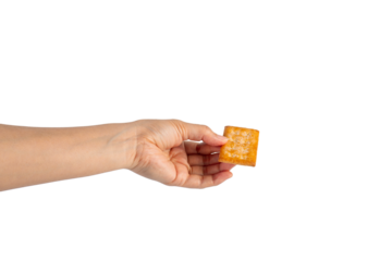 Square cracker in hand on transparent background