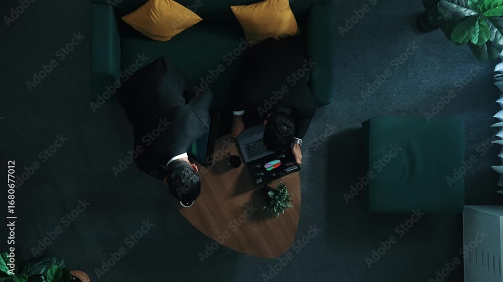 Poster top down aerial view of professional project manager walking to workspace and working on tablet whil