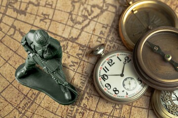Little plastic toy army soldiers on map background