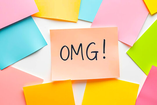 Flat lay of colorful notes with text OMG on pink note