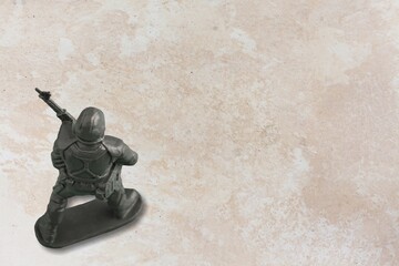 Little plastic toy army soldiers on background