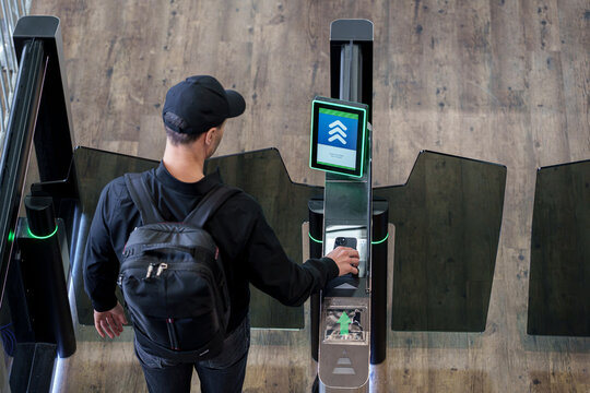 Passenger scanning QR code at airport boarding gate for check-in and flight access