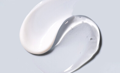 samples of cosmetic care products smear of cream and gel texture on gray background