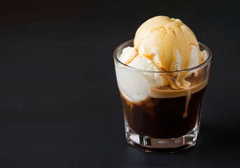 Delicious affogato with vanilla ice cream and rich espresso. Sweet affogato dessert features melting ice cream and hot espresso in glass.