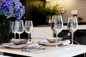 Close-up of a set table with glasses, plates and cutlery.