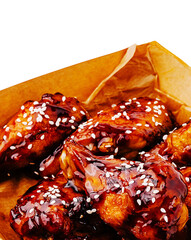 Delicious barbecue chicken wings served on parchment paper in a cozy setting