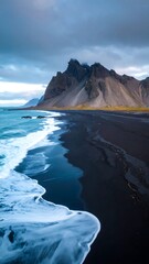 Dramatic black sand beach meets dramatic sky