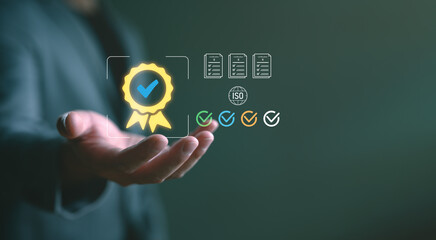 Businessman holding certification icon with checkmarks, ISO symbol, and documents. Represents...