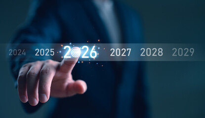 Businessman touching 2026 on a virtual timeline, symbolizing future planning, business new year...