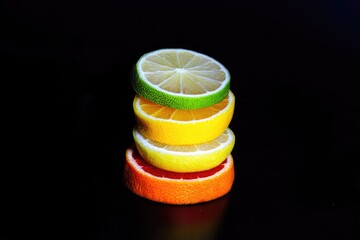 Stacked citrus slices against black background