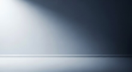 Dimly lit empty room with a bright spotlight hitting the left wall