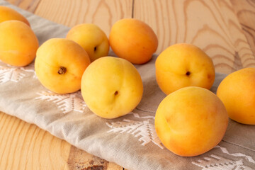Organic ripe apricots on a wooden table, close-up
