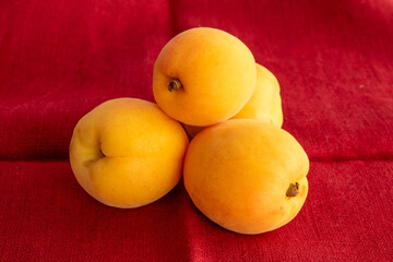 Organic ripe apricots on a linen napkin, macro.