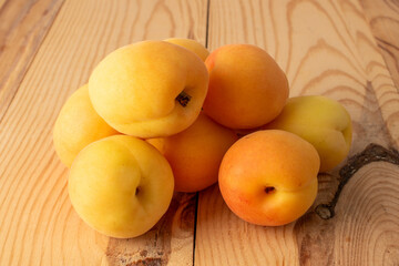 Organic ripe apricots on a wooden table, close-up