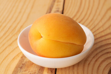 Organic ripe apricots on a wooden table, close-up