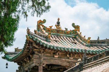 Fototapeta premium Chinese traditional taoism temple roof with tree branches, Chinese garden aesthetics
