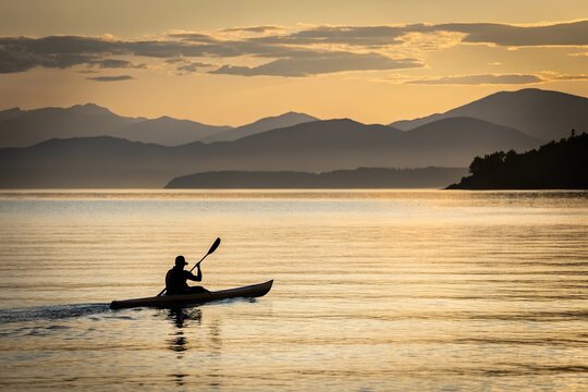 Kayak on lake at sunset. Outdoor adventure and leisure