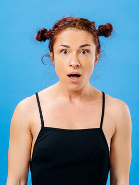 Beautiful young woman with surprise look on her face