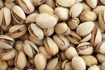 Many tasty unpeeled pistachios top view flat lay background pattern