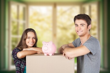 Couple moving into new house with piggy bank