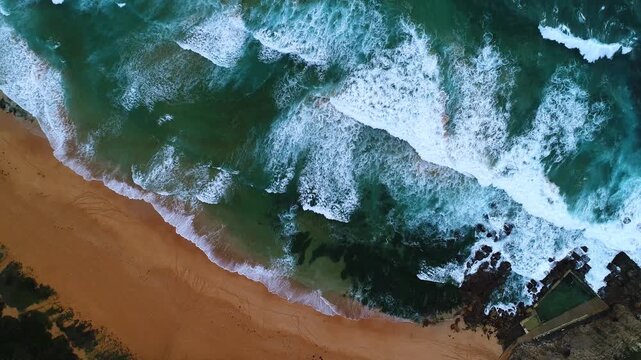 Aerial view of the striking contrast between the golden sand and the turquoise ocean, a harmonious blend of coastal beauty, Australia.