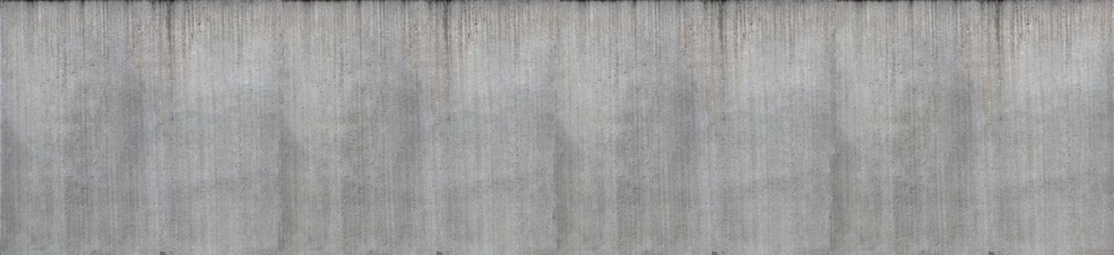 A concrete surface with a distinctly rough, irregular texture. The structure shows porous inclusions, fine cracks, formwork board marks, and irregular shadows due to the grainy surface.