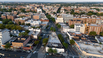 Busy city street with colorful market stalls, bustling shoppers, and cars lining