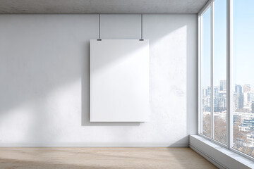 Bright sunlight streaming through large window highlighting white framed artwork against clean minimalist interior, casting soft shadows on pristine wall surface with urban landscape visible
