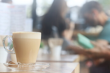 cappuccino, coffee in a clear glass cup in a cafe, soft color background food and drink, hot drink
