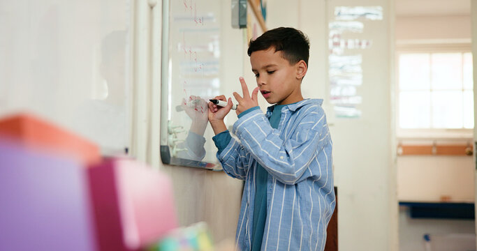 Math, child and writing on whiteboard, classroom and problem solving with calculation and knowledge. Education, counting and kid with skill development in elementary, growth and learning in school - Powered by Adobe