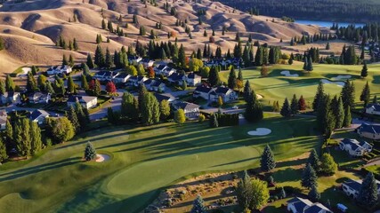 Aerial View of Residential Neighborhood and Lush Green Golf Course in Valley