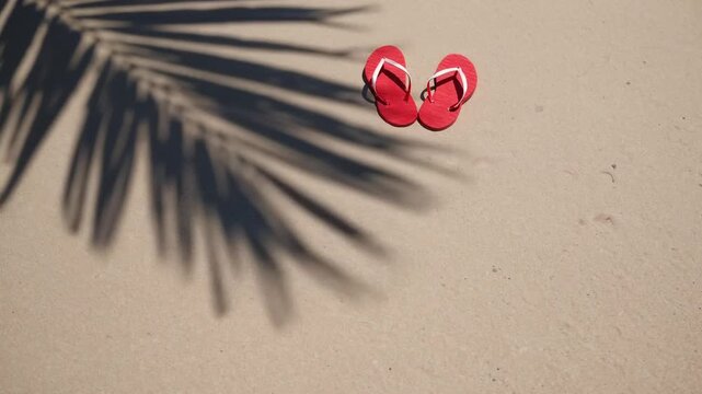 Tropical Valentine's Day Concept with Red Footwear Arranged in Heart Shape on Sandy Shore