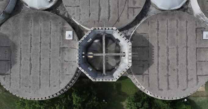 Aerial view of an octagonal tower surrounded by circular structures and patches of green, creating a stark contrast, Cincinnati, OH, United States.