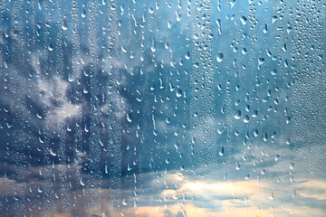 raindrops on wet glass abstract background on the backdrop of the sky