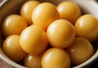 Close up of a bowl filled with golden yellow cherry tomatoes