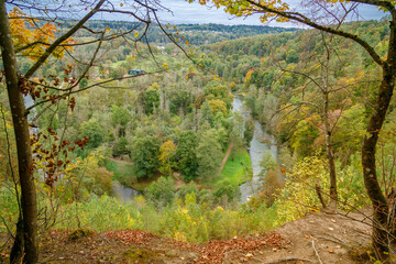 Vilnius Pavilniai Regional Park with Vilnia river flowing through a vibrant autumn forest