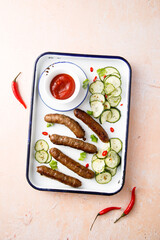 Homemade grilled sausages with cucumber salad