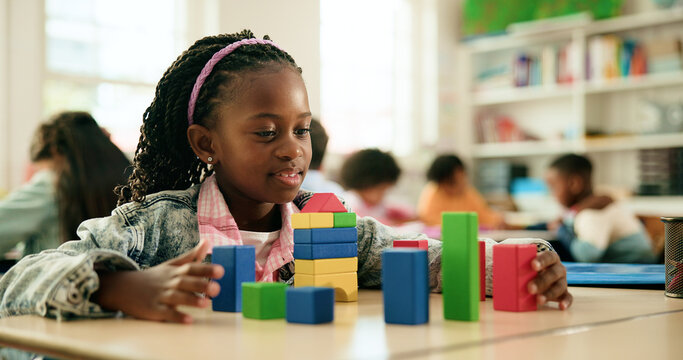 Girl, smile and building with blocks in classroom, learning and puzzle for problem solving with stack. Happy child, wood toys and development with shapes, solution and thinking at elementary school