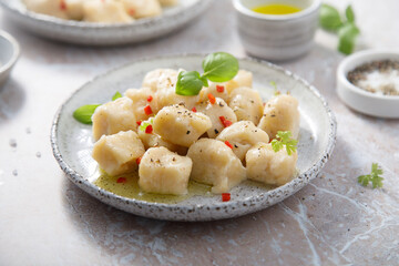 Homemade potato gnocchi with basil and chilli