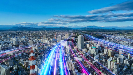 現代都市空撮と未来に向かって伸びる光の帯