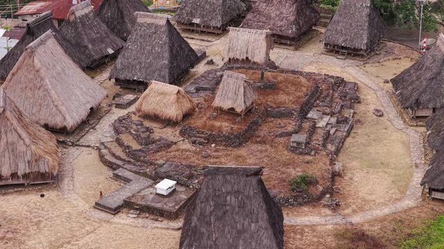 Aerial view of traditional houses with thatched roofs, clustered in Wologai Village, presenting a textured landscape, Wologai, Nusa Tenggara Timur, Indonesia.