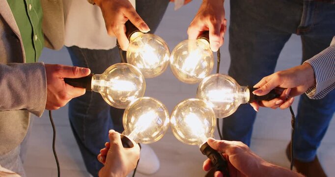 Light bulb bright idea matching, business teamwork showing new cooperation of unity and partnership. Hands close up join in office, business people putting garland together for new team business, plan