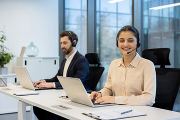 Customer service representatives working in modern office