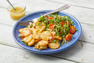 Herb roasted potatoes with arugula salad