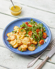 Herb roasted potatoes with arugula salad