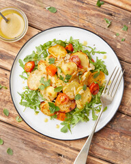 Herb roasted potatoes with arugula salad